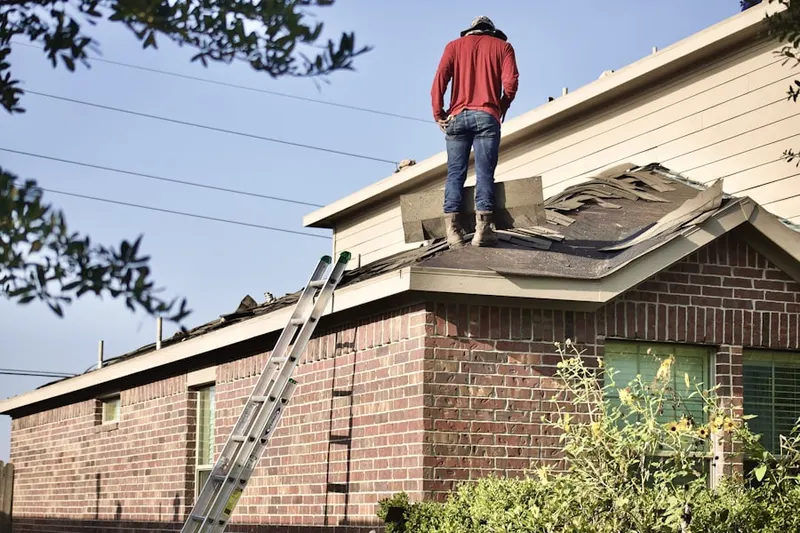 Professional roofer working on a residential roof in Laurelhurst